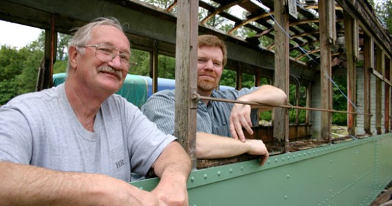 Tom and Vince Mendenhall, father-and-son owners of Arlington, Wash.-based Historic Railway Restoration, inside a  Turtleback streetcar that once operated on Tacoma streets. (PHOTO BY TODD MATTHEWS)