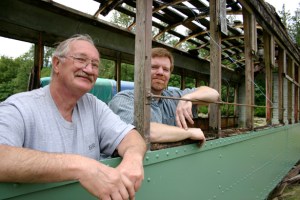 Tom and Vince Mendenhall, father-and-son owners of Arlington, Wash.-based Historic Railway Restoration, inside a  Turtleback streetcar that once operated on Tacoma streets. (PHOTO BY TODD MATTHEWS)