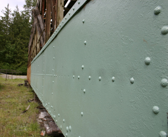 Chipped wood and flaked paint on an old door handle show the wear and tear of a Turtleback streetcar that once operated in Tacoma. (PHOTO BY TODD MATTHEWS)