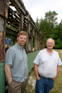 Vince and Tom Mendenhall, son-and-father owners of Arlington, Wash.-based Historic Railway Restoration, outside a 1908 Turtleback streetcar that once operated on Tacoma streets. (PHOTO BY TODD MATTHEWS)