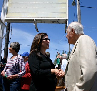 Christine Zemanek, executive director the Gary E. Milgard Family Foundation, and local developer Hugh S. Ferguson discuss Tacoma Goodwill's new job center during Wednesday's groundbreaking ceremony. (PHOTO BY TODD MATTHEWS)
