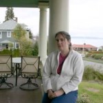 Architectural historian Caroline T. Swope on the porch of her 100-year-old Colonial Revival home in Tacoma's North End. The home has played an important role in Tacoma history. (PHOTO BY TODD MATTHEWS)
