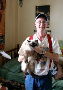 "It was kind of like my fate to live here," says Winthrop resident David Miller with a laugh. "Maybe when I die, I'll be a ghost in the hallways." Miller shares a studio on the eighth floor of the former historic hotel in downtown Tacoma with his cat 'Little Bit.' (PHOTO BY TODD MATTHEWS)