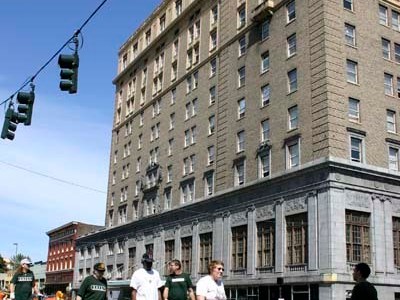 Winthrop residents cross Ninth Street outside their apartment building during a neighborhood clean-up effort Saturday. (PHOTO BY TODD MATTHEWS)
