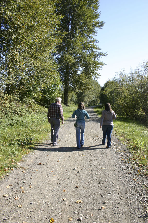 Peters, Johnson, and Chase walk along the Puyallup River searching for old flood drift barriers. (PHOTO BY TODD MATTHEWS)