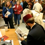 R. R. Anderson signs copies of his book of political cartoons at King's Books in Tacoma. (PHOTO BY TODD MATTHEWS)