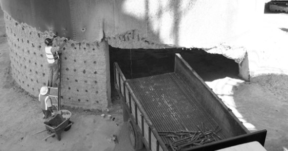 Darrell Ogden loads explosives into the base of a smokestack on the former Kaiser Aluminum site on the Port of Tacoma tide flats. The 500-foot tower was demolished on July 2, 2006, to make room for future growth at the port. (FILE PHOTO BY TODD MATTHEWS)