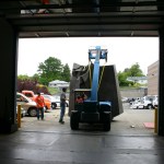 Employees working for D & D Construction prepare to move one section of the three-ton, 15-foot-tall, 22-foot-wide bronze-and-steel Sun King sculpture out of storage at the City of Tacoma's Fleet Operations Headquarters and onto flatbed trailers for transport to a public park near Thea Foss Waterway. (PHOTO BY TODD MATTHEWS)
