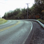 A stretch of 9th Street East, between 190th Avenue East and 198th Avenue East, was reconstructed to enhance safety by re-aligning and regrading the roadway to increase sight distances. The road was closed in June to allow a Pierce County contractor to excavate the site and lay asphalt. The road was re-opened last week, nearly two weeks ahead of schedule. Crews will continue to work along the roadway through September in order to allow crews to complete planting preparation aspects of the project. Periodic lane restrictions are expected during that time. (IMAGE COURTESY PIERCE COUNTY)