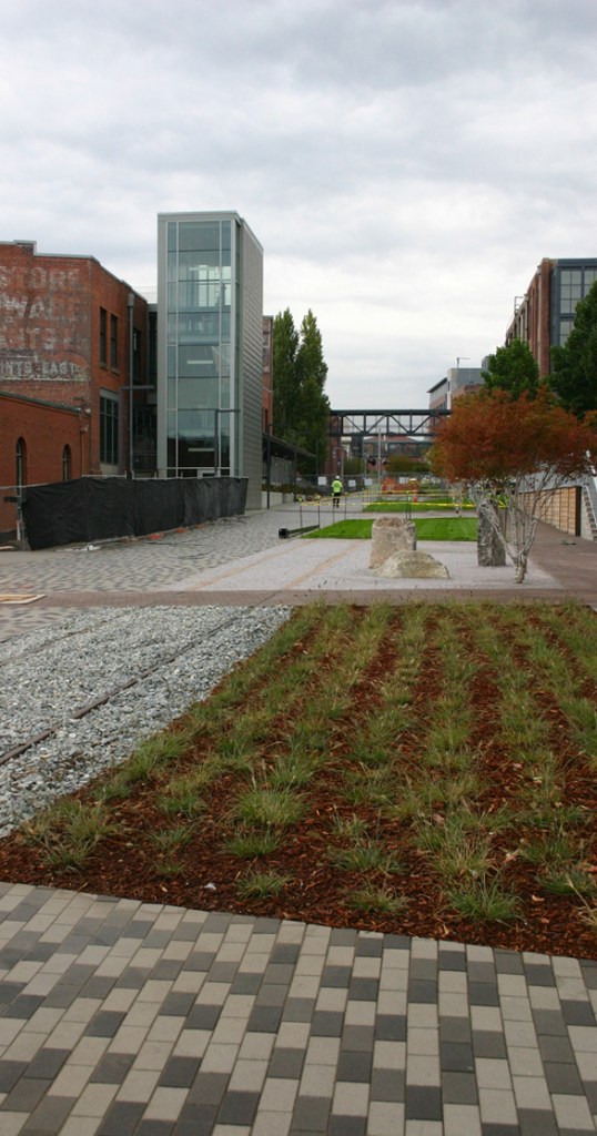 Contractors on Tuesday were putting the finishing touches on a segment of the Prairie Line Trail that runs through the University of Washington Tacoma (UWT) campus. City of Tacoma and UWT officials will celebrate the grand opening of the first phase of the new urban trail during a public ceremony on Thurs., Sept. 25, at 5 p.m. (PHOTO BY TODD MATTHEWS)