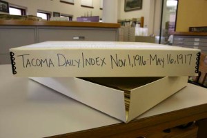 A box stored in the archives at Tacoma Public Library's Northwest Room contains issues of the Tacoma Daily Index that date back to 1916. (PHOTO BY TODD MATTHEWS)