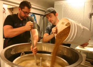 Jesse Dunagan (right) and Jon Russell prepare an Irish stout at Dunagan Brewing Co. in downtown Tacoma. (PHOTO BY TODD MATTHEWS)
