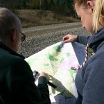 Barbara Reid and Hancock Forest Management Assistant Forester Heather A. Watson consult a map en route to the heart of Vancouver Notch in October. A section of The Divide is in the distance. (PHOTO BY TODD MATTHEWS)