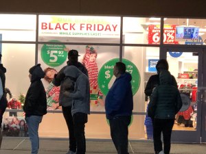 Standing in the cold, under the bright lights of a not-so-starry sky, seems to be what the holidays are all about. Photo: Morf Morford