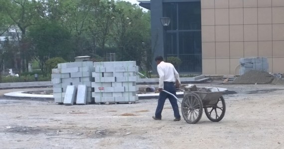 If you visit China you will be immediately struck by two things; first, the Chinese have no problem using futuristic technology alongside the most ancient processes (this worker is building an entryway of blocks of granite to a university building in Zheijiang, home of Alibaba) and second, the Chinese are not afraid of hard work. Photo: Morf Morford