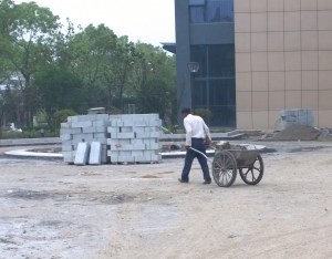 If you visit China you will be immediately struck by two things; first, the Chinese have no problem using futuristic technology alongside the most ancient processes (this worker is building an entryway of blocks of granite to a university building in Zheijiang, home of Alibaba) and second, the Chinese are not afraid of hard work. Photo: Morf Morford