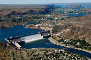 June 30, 2011: Aerial view of Grand Coulee Dam releasing downstream an unusually large and late spring time water flows of over 200,000 cfs. Broken out, it&rsquo;s 33,800 cfs, over the spillway and 167,000 cfs through the hydropower generators. Image courtesy Bureau of Reclamation