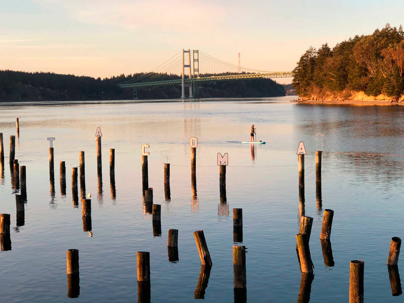 This photo captures a hint of the history, beauty, art and activities available in this local park. Be sure to notice Tacoma cleverly spelled out on the historic pilings that were part of the landing for the 6th Avenue Ferry that ran before the Narrows Bridge was built/rebuilt. (Photo by Morf Morford)