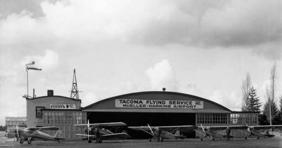 This Tacoma Flying Service Hangar, built in the 1920s, is still standing and is currently being used as a large workspace by Clover Park Technical College. Photo (circa 1940s) courtesy Northwest Room at The Tacoma Public Library, Richards Studio D9405-2.