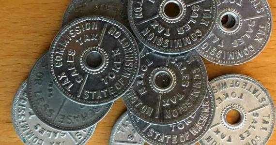 These are Washington state tax tokens. Instead of charging an extra few cents, tax tokens could be purchased and applied to a sale. Several states had these. Washington used them until 1951. (Photo by Morf Morford)