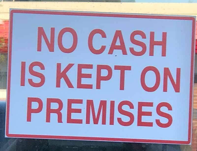 This sign was on an upscale boutique in one of Tacomas premier neighborhoods. Theres something about a crooked No cash sign in a good neighborhood that is pure Tacoma. (Photo by Morf Morford)