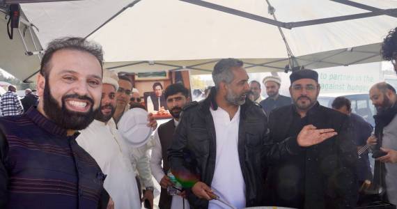 Men serving halal food on Eid Mubarak 2024. Photo By Joshua Solorzano/Sound Publishing