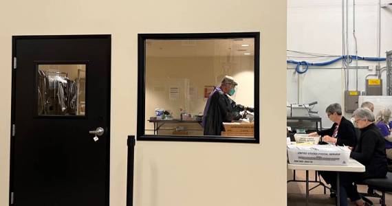 Election workers open mail in a new secure room at Thurston Countys elections office. The county invested in a separate room to open mail after it was sent an envelope containing fentanyl last year. (Laurel Demkovich/Washington State Standard)