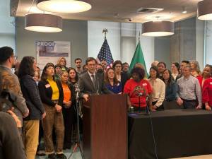 Photo by Jake Goldstein-Street/Washington State Standard 
Gov. Bob Ferguson, podium, makes remarks during a bill signing event on May 7, 2025, where he signed a law that will cap rent increases for many residential tenants across Washington at 10% or less annually.