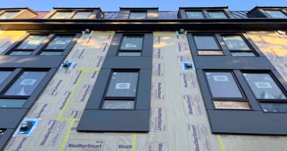 An apartment building under construction in Olympia, Washington in January 2025. Critics of a proposal to cap rent increases in Washington argue that it could stifle new development. (Photo by Bill Lucia/Washington State Standard)