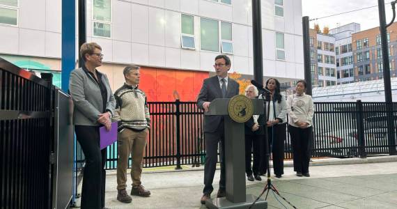 Washington Gov. Bob Ferguson speaks to Andi Smith of the Ballmer Group after the announcement of a major new philanthropic donation to fund early childhood education on Wednesday, Nov. 12, 2025, at the Denise Louie Education Center in Seattle, Washington. (Photo by Jake Goldstein-Street/Washington State Standard)