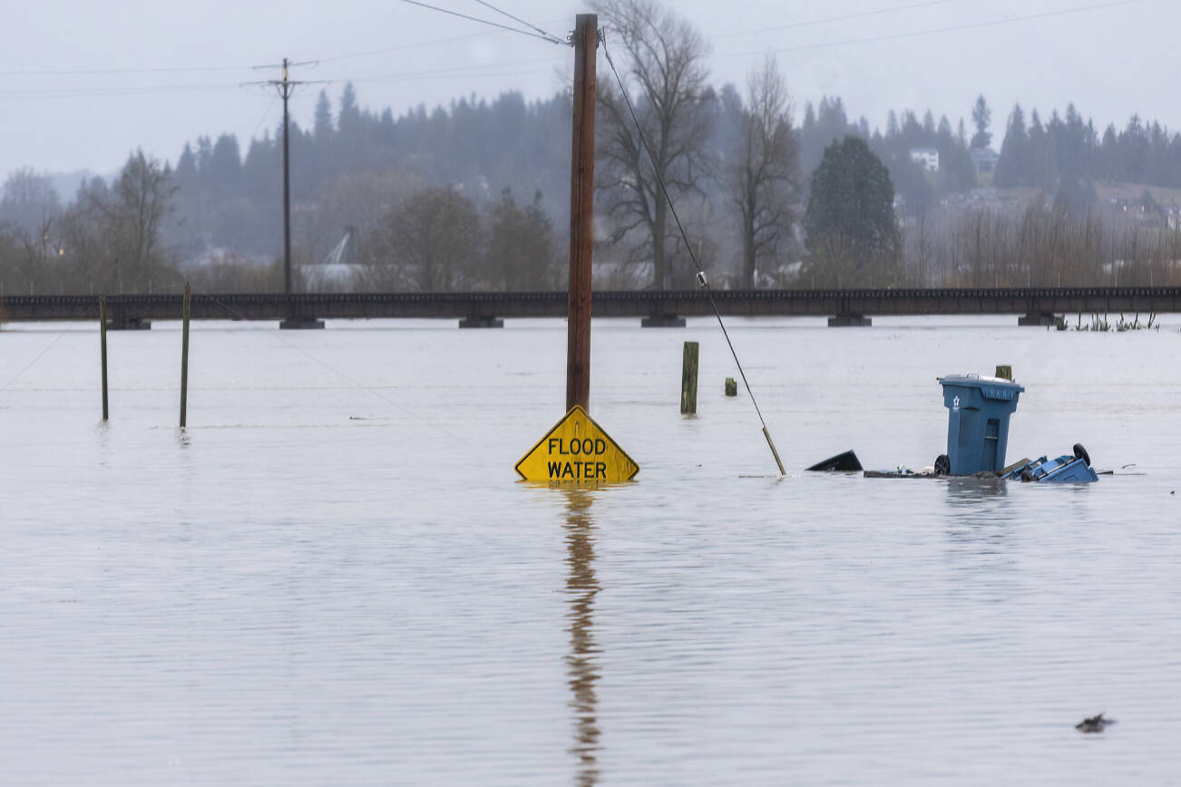 Floodwater from the Snohomish River partially covers a flood water sign on Dec. 11, 2025 in Snohomish, Washington. (Sound Publishing photo)