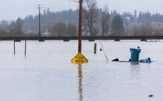 Floodwater from the Snohomish River partially covers a flood water sign on Dec. 11, 2025 in Snohomish, Washington. (Sound Publishing photo)