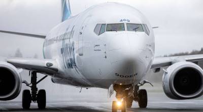 Water drips from an Alaska Airlines Boeing 737 after it received a water salute while becoming the first scheduled 737 arrival Thursday, Feb. 17, 2022, at Paine Field Airport in Everett, Washington. (Ryan Berry / The Herald)